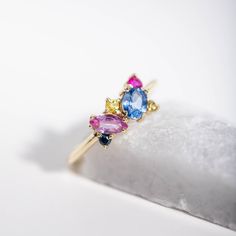 A rainbow cluster ring with multicolor sapphires and rubies in 14K gold. This statement ring for women is a great idea for an anniversary gift for her. 100% handcrafted with love! ● Metal: 14K solid gold ● Gemstone: Blue Sapphire oval cut, Pink Sapphire marquise cut, Yellow and multicolor Sapphires round cut, Ruby round cut ● Weight: Blue Sapphire 0.56 ct, Pink Sapphire 0.26 ct, Multicolor Sapphires 0.14 ct, Ruby 0.09 ct R I N G ∙ S I Z I N G For General Reference: ● we use standard US Ring Sizi Multicolor Sapphire Multi-stone Ring, Multicolor Multi-stone Sapphire Ring, Multicolor Sapphire Ring In Fine Jewelry Style, Rainbow Sapphire Ring Fine Jewelry Gift, Rainbow Sapphire Ring As Gift, Rainbow Sapphire Ring For Gift, Multicolor Multi-stone Cluster Ring As Gift, Rainbow Multi-stone Sapphire Ring In Fine Jewelry Style, Rainbow Multi-stone Sapphire Ring