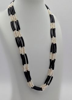 A nice four-strand beaded necklace featuring faux pearls and black tube beads. The necklace measures 17" long with a 2" gold-tone extension chain, closing with a spring-ring clasp. The beaded necklace is from the 1980s and is unmarked, but very well-made and in excellent condition. N4_833 Cheap Hand-strung Black Beaded Necklaces, Formal Black Multi-strand Beaded Necklace, Elegant Black Multi-strand Beaded Necklaces, Handmade Multi-strand Black Necklace, White Beaded Necklaces, Black Tube, Black Multi-strand Costume Jewelry Necklace, Tube Beads, White Beads