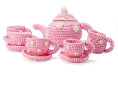 pink crocheted tea set with cups and saucers