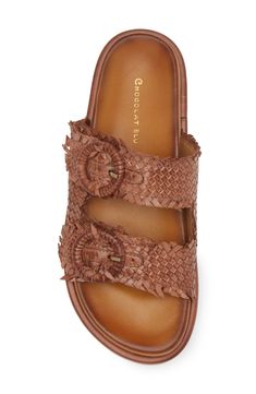 Woven leather straps crisscross over the vamp of a weekend-ready slide sandal set on a cushioned footbed and flexible outsole. Adjustable straps with buckle closures Leather upper and lining/synthetic sole Imported Chic Brown Slides With Leather Footbed, Brown Slides With Leather Footbed, Brown Slides With Leather Footbed And Flat Heel, Brown Leather Footbed Slides With Flat Heel, Adjustable Brown Footbed Sandals With Leather Sole, Chic Brown Slides With Round Toe, Brown Double Strap Footbed Sandals With Leather Sole, Brown Double Strap Sandals For Vacation, Brown Double Strap Sandals With Leather Footbed