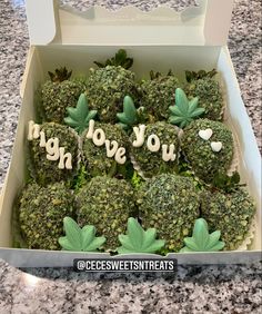 a box filled with broccoli covered in green leaves and words that spell love you