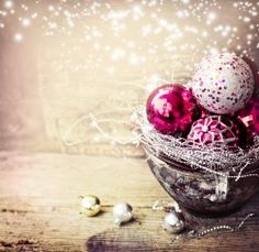 a bowl filled with ornaments on top of a wooden table