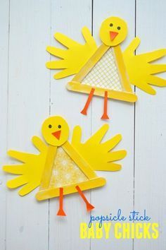 two yellow paper cut outs with birds on them