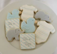 baby shower cookies are arranged on a plate