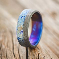 a wooden ring with blue and purple paint on it