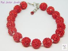 Perfect for a party or simply to add sparkle to your outfit!  Red disco ball beads are covered in rhinestones to shine and shimmer.  Bracelet is 8 inches long with a 0.5-inch extender chain, accented with a tiny red bead, to adjust the length.   All of my jewelry is carefully hand-crafted at the time that you order, so please allow an extra day or so for the creation of your bracelet before I ship to you. * Matching sparkly earrings can be found here:  https://www.etsy.com/listing/1381856353 * Thank you for shopping with Mad Jester Jewelry! Red Disco Ball, Sparkly Bracelets, Outfit Red, Woven Chain, Sparkly Earrings, Red Bead, Disco Ball, Adjustable Bracelet, Bead Bracelet