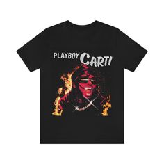 This is a custom design I created as a tribute for artist Playboy Carti. * Soft cotton and quality print. * Ribbed knit collars to bolster shaping.  * Tapered shoulders for a better fit. * Dual side seams hold the garment's shape for longer.  * 100% Airlume combed and ringspun cotton (fiber content may vary for different colors) * Light fabric (4.2 oz/yd² (142 g/m * Retail fit * Tear away label * Runs true to size Hope you enjoy and send photos. Band Merch Cotton T-shirt With Custom Artwork, Cotton Band Merch T-shirt With Custom Artwork, Cotton T-shirt With Custom Artwork Fan Merchandise, Cotton T-shirt With Custom Artwork For Fans, Cotton Tops With Custom Band Artwork, Cotton Tops With Custom Artwork For Streetwear, Band Merch Tops With Custom Artwork, Band Merch T-shirt With Custom Artwork For Streetwear, Black Music-themed T-shirt With Sublimation Print