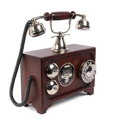 an old fashioned phone with three dials on the front and two bells on the back