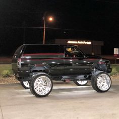 a black truck parked in front of a building