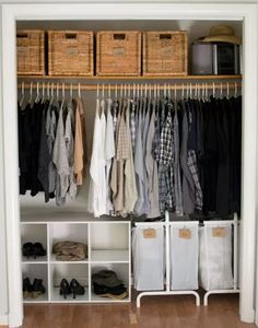 an organized closet with clothes and baskets