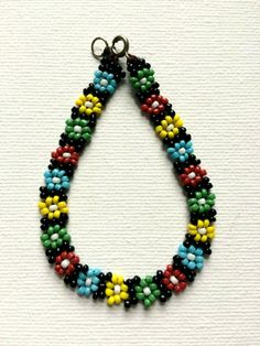 a multicolored beaded necklace on a white background