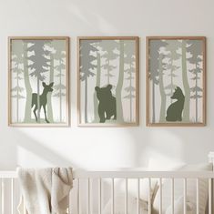 two framed pictures hang above a crib in a baby's room