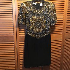 Black Silk Short Sleeve Dress Featuring Gold Sequins, Gold And Clear Beads And Pearls Designs Throughout The Top, Lines Of Black Vertical Beads Throughout The Bottom, 4 Rows Of Horizontal Beads Around The Bottom And Around The 6” Split In The Back Zippered Back. Size Small. Measures 18” From Underarm To Underarm 38” From Shoulder To Bottom. 100% Silk; Lining 100% Polyester. Nwot Elegant Black Dress With Beaded Fringe, Vintage Black Embellished Dress, Black Beaded Vintage Dress, Festive Black Beaded Dress, Navy Blue Midi Dress, Leaves Print Dresses, Vogue Dress, Silk Shift Dress, Flare Sleeve Dress