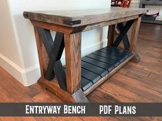 the entry bench is made from wood and has black metal straps on it's legs