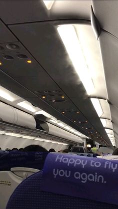 the inside of an airplane that is happy to fly you again sign on the seat