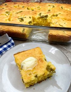 a piece of cake on a plate next to a casserole dish