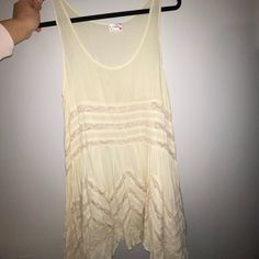 Never Worn Flowy Long Tunic Tank Top. Can Be Worn As A Dress. Size Medium And Large Available. Sleeveless Cotton Mini Dress For Beach Cover-up, Sleeveless Beach Dress With Ruffles, Daytime Sleeveless Mini Dress With Lace Trim, Sleeveless Beachwear Tops For Spring, Spring Beach Cover-up Tops With Lace Trim, Sleeveless Ruffled Beach Dress Cover-up, Beige Sleeveless Sundress For Beachwear, Cream Sleeveless Summer Dress, Flowy Sleeveless Beach Dress With Ruffles