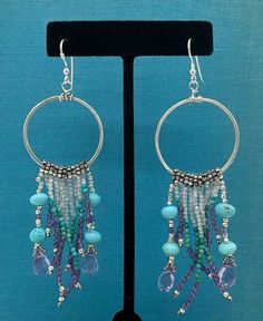 Turquoise, amethyst, and white zircon beads adorn these handmade hoop earrings. Length approximately 3 inches. Bohemian Beaded Hoop Earrings In Sterling Silver, Bohemian Purple Hoop Earrings With Round Beads, Bohemian Purple Hoop Earrings, Bohemian Purple Round Hoop Earrings, Purple Bohemian Hoop Earrings, Purple Bohemian Round Hoop Earrings, Pumpkins Crafts, Diy Pumpkins Crafts, Diy Pumpkins