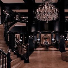 a large foyer with chandelier and stairs leading up to the second floor area