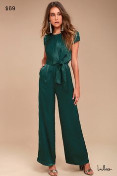 Be the perfect hostess in the Lulus Let Me Entertain You Forest Green Satin Wide-Leg Jumpsuit! Silky satin shapes a rounded neckline, cap sleeves, and a tying waist sash that creates a chic, knotted accent. Wide-leg pants with diagonal front pockets. Hidden back zipper/clasp. Fit: This garment fits true to size. Length: Floor length. Size medium measures 61" from shoulder to hem. Inseam: 31.25 Front Rise: 13.00 Bust: Great for any cup size. Waist: Fitted - very fitted at natural waist. Hip: Not Fitted Green Bottoms With Tie Waist, Fitted Short Sleeve Jumpsuit With Tie Waist, Fitted Belted Jumpsuits And Rompers In Solid Color, Fitted Short Sleeve Jumpsuits And Rompers With Tie Waist, Solid Color Belted Fitted Jumpsuits And Rompers, Fitted Solid Color Belted Jumpsuits And Rompers, Green Bottoms With Tie Waist, Green Fitted Short Sleeve Jumpsuit, Fitted Green Jumpsuits And Rompers With Tie Waist