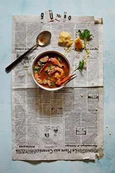 a bowl of soup on top of a newspaper