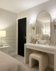 a bedroom with a large mirror and dressing table