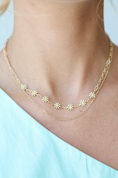 Cute and colorful meets upscale vibes in the Bridget Gold Flower Charm Layered Necklace! This trendy necklace features two layers of gold chains with flower charms. Style the Bridget Necklace with any outfit to instantly add a chic touch to your look! Available in 3 colors. Gold Plated Layered Flower Charms Lobster Clasp with Extender Layer 1 | Length 7.5" Layer 2 | Length 7" Extender | Length 3" Trendy Gold Jewelry For Spring, Trendy Flower Necklace With Flower Charm Pendant, Trendy Flower Pendant Necklace With Charm, Trendy Flower Necklace With Flower Pendant, Trendy Summer Flower Charm Necklace, Spring Adjustable Gold Chain Jewelry, Gold Jewelry With Adjustable Chain For Spring, Trendy Flower Necklace For Spring, Trendy Flower Charm Necklace For Spring