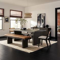 a dining room table with two chairs and a bench