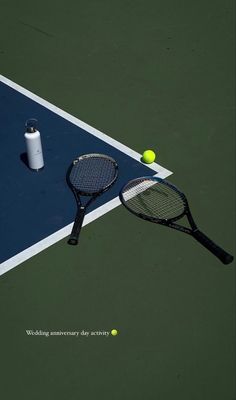 a tennis racket and ball on the court