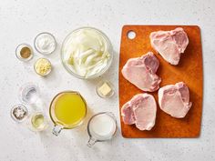 the ingredients to make an appetizer are laid out on a cutting board, including meat and butter