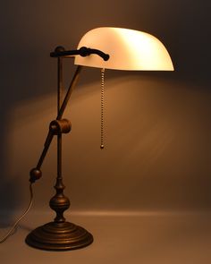 a lamp that is sitting on top of a table next to a light bulb and plugged in