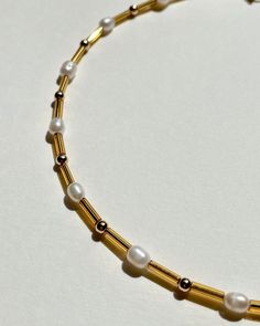 A lighter version of our classic choker. Golden glass mini beads, gold plated beads, and freshwater pearls. Choker lite is 13 inches long plus a 2-inch extension chain made of gold plated stainless steel and gold plated stainless steel lobster clasp. Hand-made by Karo at her home in Los Angeles. Handle with care. Minimalist Gold Pearl Choker, Gold Beaded Chain Pearl Choker, Gold Choker With Pearl Chain And Round Beads, Gold Minimalist Beaded Necklaces With Pearl Drop, Minimalist Gold Beaded Necklaces With Pearl Drop, Gold Minimalist Beaded Necklace With Pearl Drop, Minimalist Gold Beaded Necklace With Pearl Drop, Everyday Gold Pearl Necklace With Tiny Beads, Gold Beaded Pearl Charm Choker Necklace