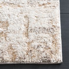 an area rug with white and brown colors