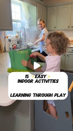 two children are playing with toys in the kitchen