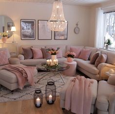 a living room filled with lots of furniture next to a fire place and chandelier