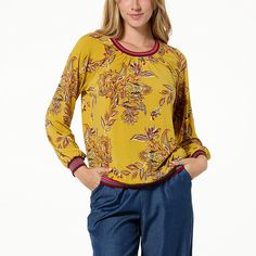 IMAN Global Chic Runway Jersey Printed Top with Ribbed Trim Make a grand entrance — or exit — in this head-turning raglan-sleeve top. With the bold print and contrasting ribbed trim, it's not something you see everyday. Fall Yellow Crew Neck Blouse, Multicolor Geometric Embroidered Long Sleeve Top, Multicolor Graphic Print Long Sleeve Top, Luxury Long Sleeve Multicolor Print Top, Red Graphic Print Raglan Sleeve Top, Multicolor Relaxed Fit Top With 3/4 Sleeves, Raglan Sleeve Top, Chiffon Fashion, Grand Entrance