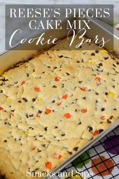 reese's pieces cake mix cookie bars in a baking pan on a cooling rack