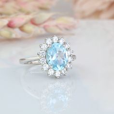 Beautiful Halo Aquamarine Ring ►Made of solid sterling silver with rhodium finish (925) ►Accented with simulated diamonds (CZ) ►Average band width: 1.7 mm Center Stone: Aquamarine Shape: Oval Size: 7.0 x 9.0 mm Carat Weight: 2 ct. (approx.) Gemstone creation: Lab-grown Hardness: 8-8.5 ✓ 100% Nickel-Free ✓ Hypoallergenic ✓ Comfort Fit ✓ Free Ring Box ✓ Free USA Shipping ✓ Ready to ship next business day Oval Topaz Ring With Halo For Anniversary, Anniversary Oval Topaz Ring With Halo, Oval Halo Topaz Ring For Anniversary, Wedding Ring With Halo Blue Topaz, Oval Topaz Ring With Center Stone For Anniversary, Oval Halo Birthstone Ring For Anniversary, Oval Halo Ring With Birthstone For Wedding, Oval Halo Birthstone Promise Ring, Anniversary Birthstone Oval Cluster Ring