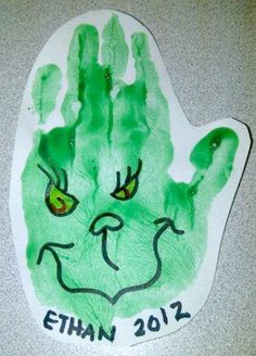 a green handprint with the name ethan 2012 on it and an evil face