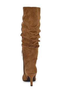 A slender heel and pointed toe define the seductive silhouette of a faux-suede boot finessed with a slouchy shaft. 3" heel 15" shaft, 14" opening circumference Partial side zip closure Textile upper, lining and sole Imported Classic Slippers, Faux Suede Boots, Flip Flop Slippers, Clutch Pouch, Ugg Classic, Halloween Fashion, Sweaters And Leggings, Suede Boots