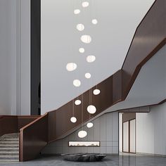 a staircase with several lights hanging from it's sides and a circular light fixture above