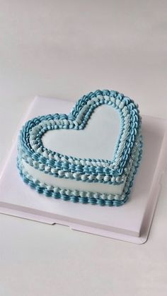 a heart shaped cake sitting on top of a white plate