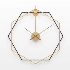 a gold clock with black and white lines on it's face in the shape of a hexagonal structure