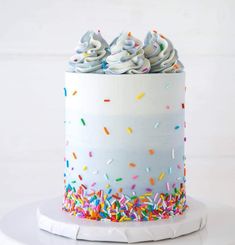 a white cake with sprinkles and frosting