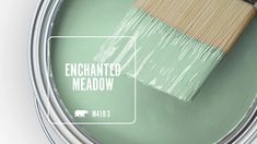 a paint can with a brush in it and the words, enchanted meadow