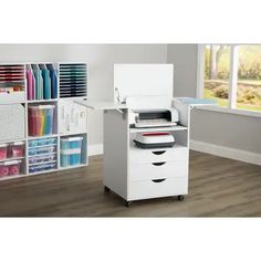 a white desk with three drawers and a printer on the top shelf next to it