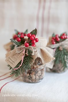 two small jars filled with candy canes and pine cones on top of a table