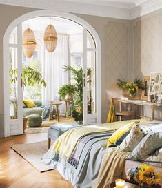 a bedroom with an arched window, bed and couch in it's center area