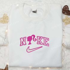 Barbie x Nike Cartoon Embroidered Sweatshirt, Cartoon Embroidered Shirt, Best Birthday Gift Ideas for Family Introducing Tinicloset, the epitome of iconic fashion where creativity and style converge to create personalized masterpieces that define your unique sense of self. At Tinicloset, we specialize in crafting custom embroidered apparel, ranging from enchanting Barbie x Nike Cartoon embroidered... Crew Neck Tops With Machine Embroidery For Gifts, Long Sleeve T-shirt With Machine Embroidery As Gift, Pink Crew Neck Sweatshirt With Machine Embroidery, Long Sleeve Tops With Letter Embroidery For Birthday, White Embroidered Sweatshirt For Gift, White Embroidered Sweatshirt As Gift, Pink Crew Neck T-shirt With Machine Embroidery, Long Sleeve T-shirt With Embroidered Logo As Gift, Embroidered Crew Neck Top For Birthday