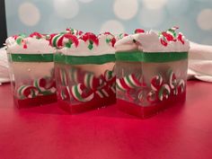 three cups with candy canes in them sitting on a table